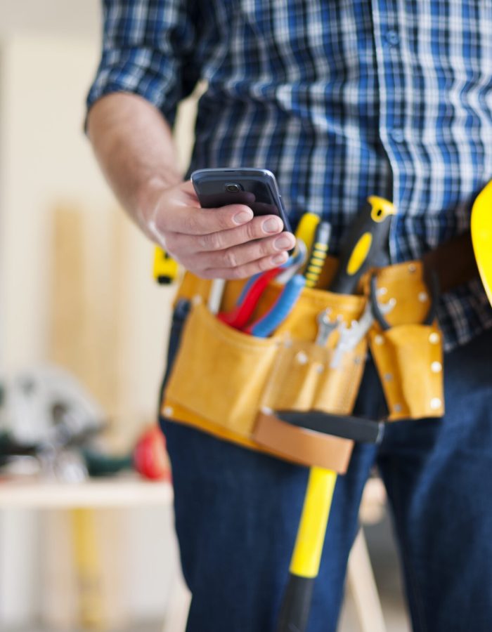 Close up of construction worker with mobile phone